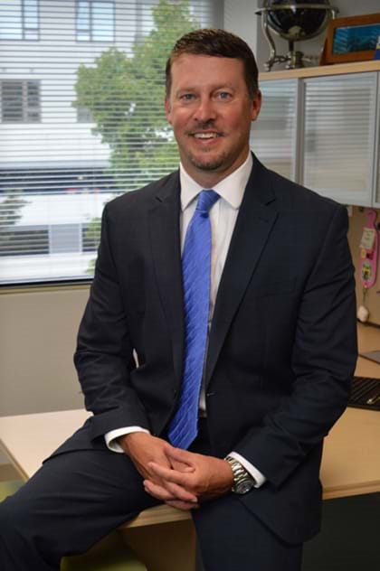 Ben Ricks, Vice President of Marathon Consulting in Virginia Beach standing in his office.