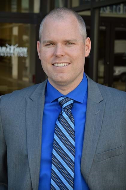 Tom Marsden, Associate Vice President of Marathon Consulting in Virginia Beach standing outside the office.