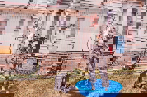 Business man standing in wading pool - represents lack of work - life balance